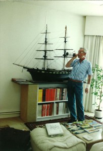 A picture taken of Bob De Moor in front of the model of an English merchant brig from 1850.